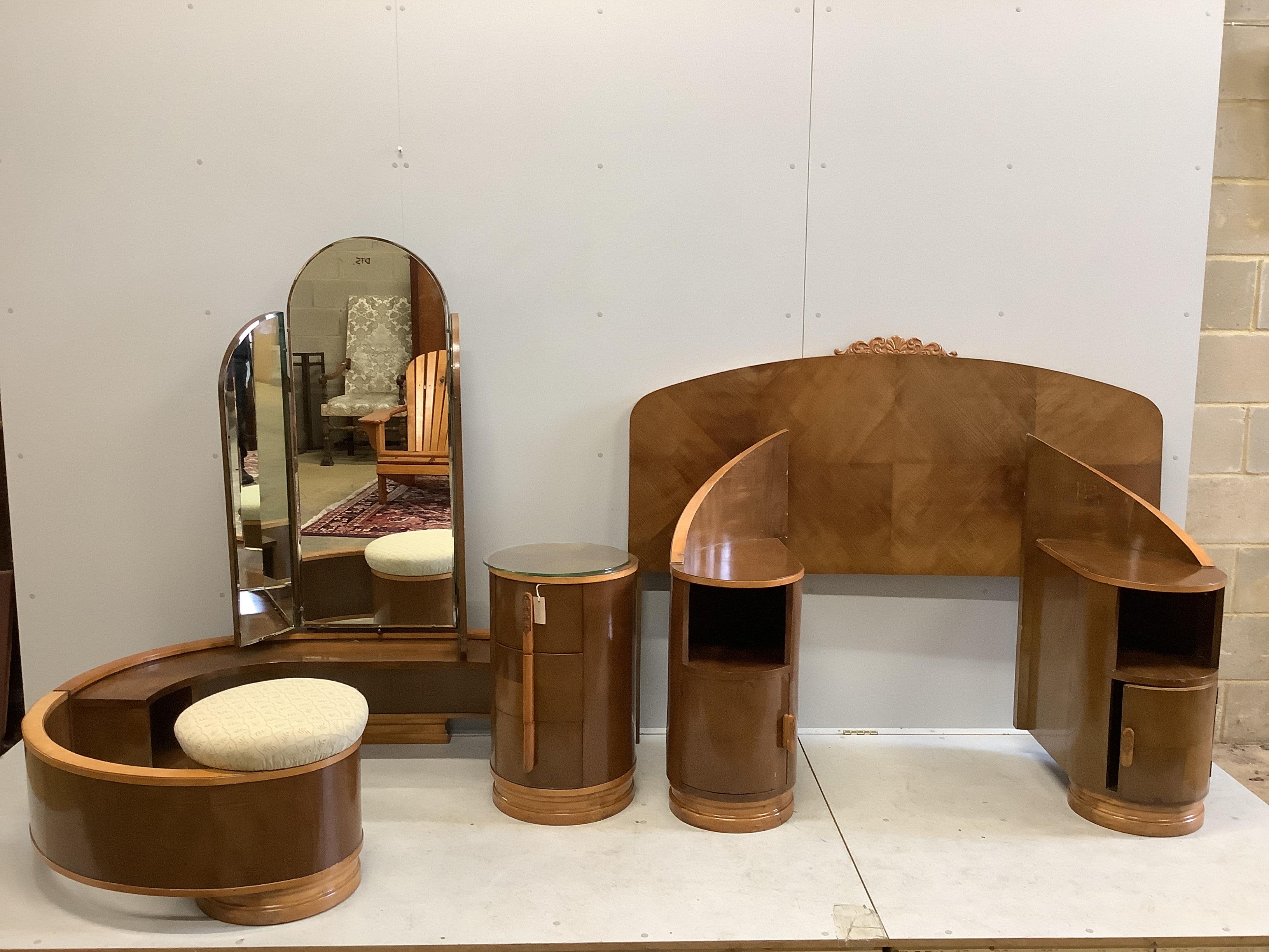 An Art Deco curved walnut dressing table, width 160cm, depth 106cm, height 156cm together with a matching headboard with integral bedside cabinet, width 238cm, height 126cm